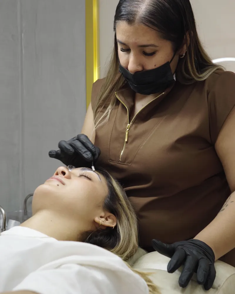 Técnica haciendo un laminado de cejas en una cabina privada de Alba Nail Studio
